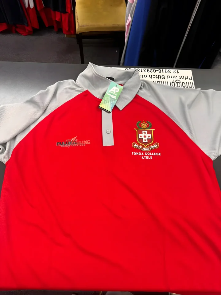 Red and grey Tonga College polo laid flat